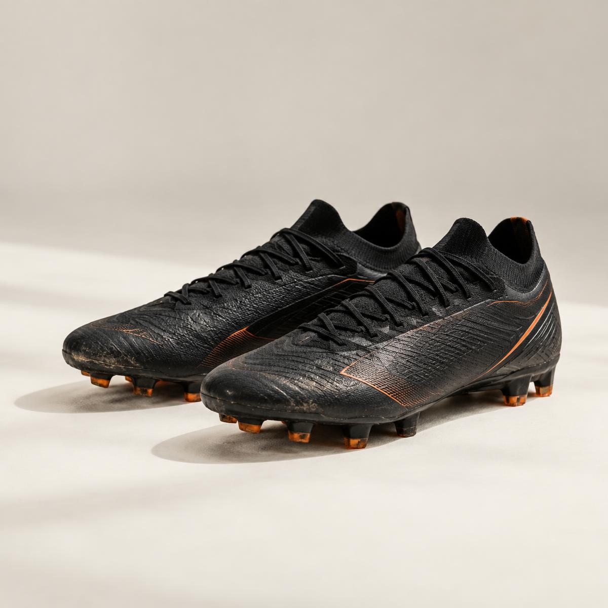 A pair of lightly used black football boots